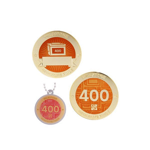 Milestone geocoin in gold with orange paint for your 400th find.  Front and back pictured, as well as the matching tag.