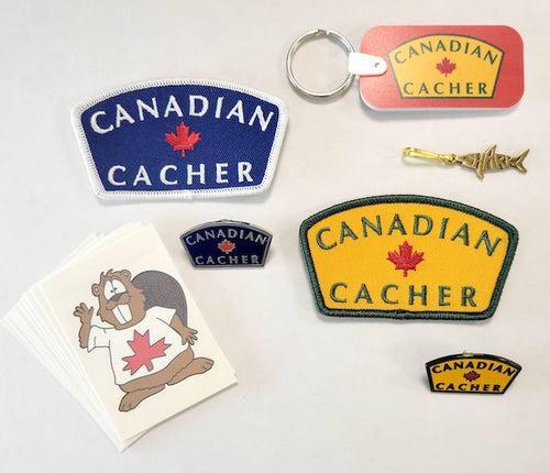 Canadian Cacher swag kit consisting of beaver dude tattoos, two Canadian Cacher patches, two Canadian Cacher pins, one landsharkz sipper pull, and a Canadian Cacher key chain