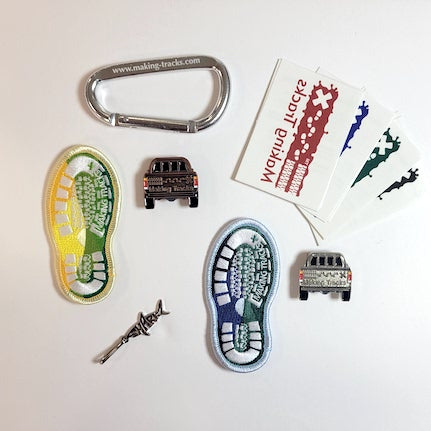 Variety of Making Tracks items including temporary tattoos, patches, carabiner, zipper pull and pins