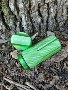 Close up of green geocache with the lid off