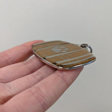 Side view of the barrel dog tag geocoin