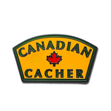 Canadian Cacher pin with yellow background and green writing with a red maple leaf in the centre