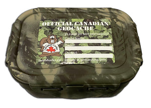 official canadian geocache sticker with ivy background, beaver dude on the right and areas to write the cache name, owner and contact details. Sticker is shown on a cache container with woodland camo paint.