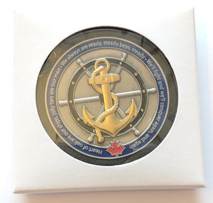 Navy coin displayed in an acrylic case with the paper box surrounding it