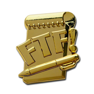 All gold FTF pin with a log book and pen that says FTF on top