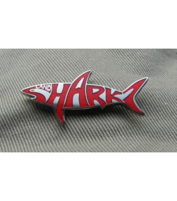 Shark shaped Landsharkz logo pin with red writing on a silver background 