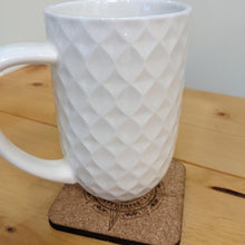 Geocaching Adventures coaster under white mug