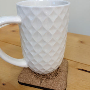 Geocaching Adventures coaster under white mug