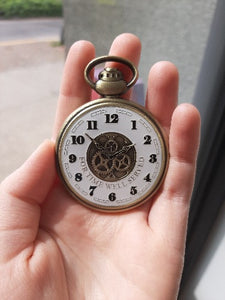 The front of the Retirement Pocket Watch Coin in someone's hand
