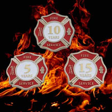 set of three pins superimposed over flaming background. The pins are done in a Maltese Cross shape  with 5, 10, and 15 years written in the centre of each