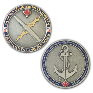 antique silver coin with shiny gold accents with the weapons engineering trade badge on one side and a fouled anchor on the other side.