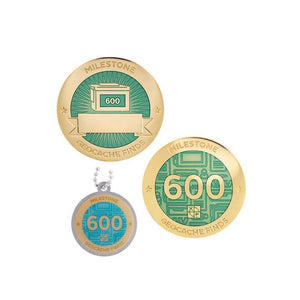 Milestone geocoin in gold with turquoise paint for your 600th find.  Front and back pictured, as well as the matching tag.