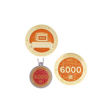 Milestone geocoin in gold with peach paint for your 6000th find.  Front and back pictured, as well as the matching tag.