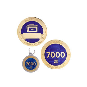 Milestone geocoin in gold with indigo paint for your 7000th find.  Front and back pictured, as well as the matching tag.