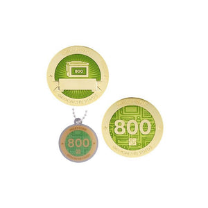 Milestone geocoin in gold with light green paint for your 800th find.  Front and back pictured, as well as the matching tag.