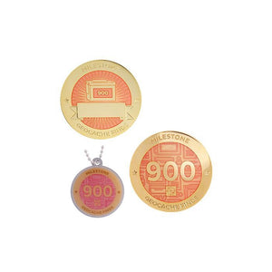 Milestone geocoin in gold with peach paint for your 900th find.  Front and back pictured, as well as the matching tag.