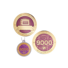 Milestone geocoin in gold with pink paint for your 9000th find.  Front and back pictured, as well as the matching tag.