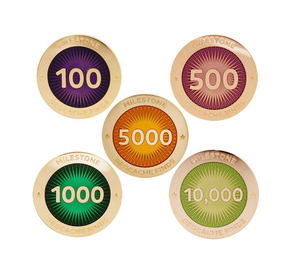 Five milestone pins pictured, all polished gold, for amounts of 100, 500, 1000, 5000 and 10000