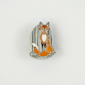 Oval shaped silver pin with an orange fox on it.