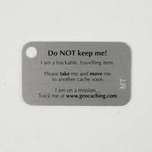 The back of a Making Tracks tag, it says "Do Not Keep me!" And explains that it is a trackable, traveling item.  There is space for a tracking code.