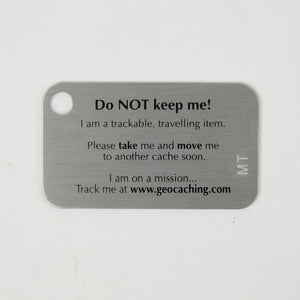 The back of a Making Tracks tag, it says "Do Not Keep me!" And explains that it is a trackable, traveling item.  There is space for a tracking code.