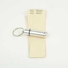Silver micro cache with Rite in the Rain logsheets 
