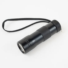 Black Ultra Violet LED Flashlight with cord switched off