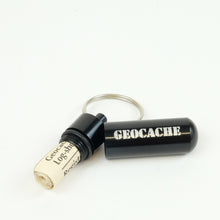 Black micro cache, open with logsheets rolled up inside 