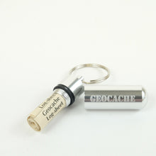 Silver micro cache with logsheets rolled up inside it
