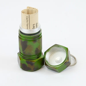 Camo mighty-mini aluminum cache with logbook rolled up inside of it 