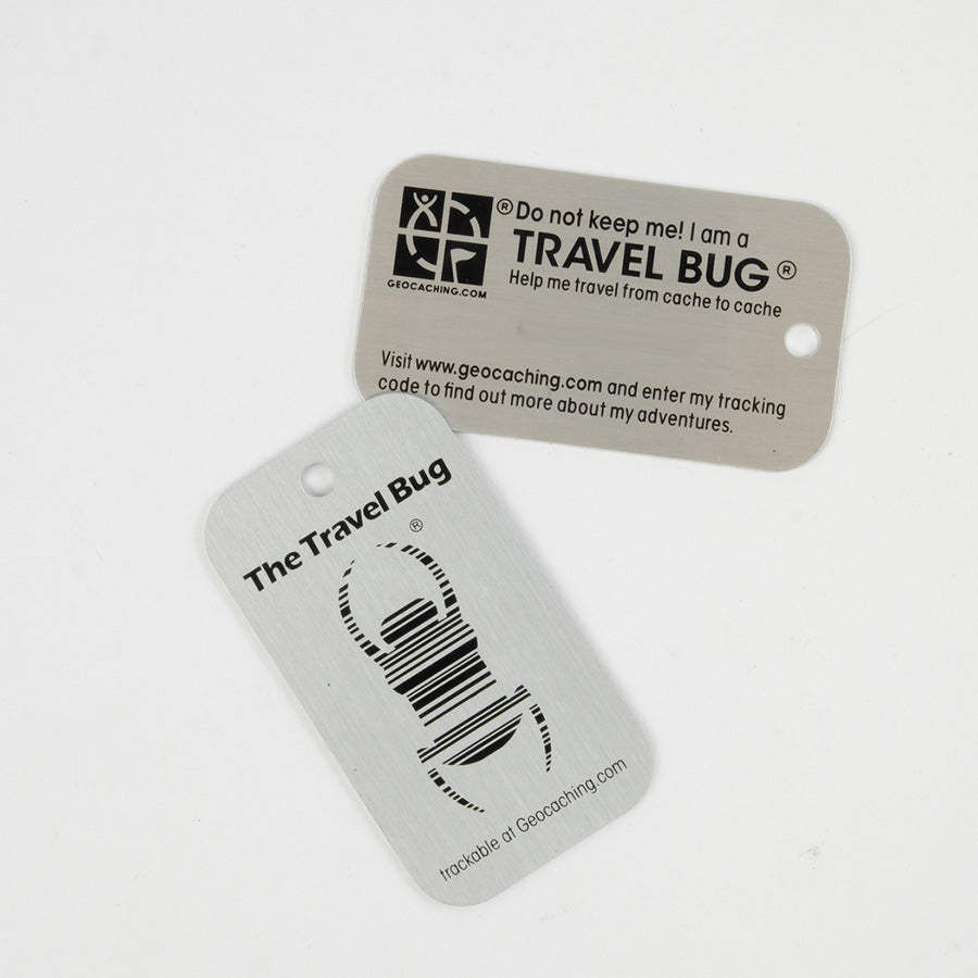Travel Bug tag, both sides pictured.  There is space on the back for a tracking number with the signature beetle on the front. 
