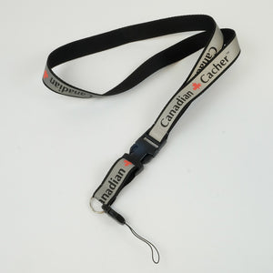 Black and reflective silver lanyard that says Canadian Cacher with a red maple leaf